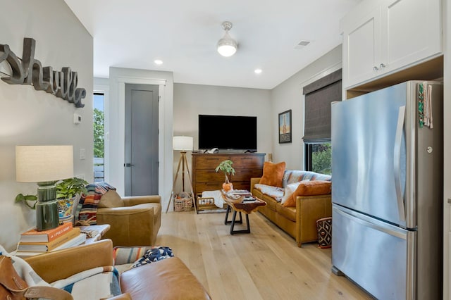 living area with recessed lighting, visible vents, and light wood-type flooring