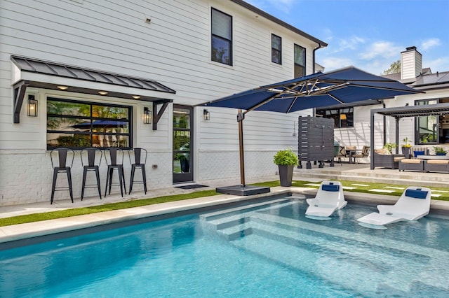 outdoor pool with a patio, a bar, an outdoor hangout area, and mail area