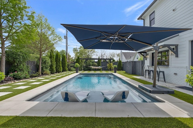 view of swimming pool featuring a patio, fence, and a fenced in pool