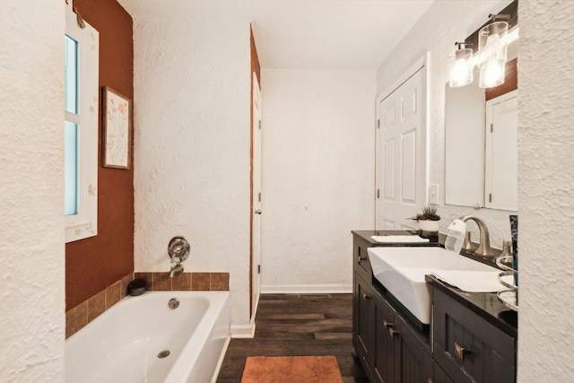 12817 Lascassas Pike, Milton, TN 37118 - full bathroom featuring a bath, wood finished floors, vanity, baseboards, and a textured wall