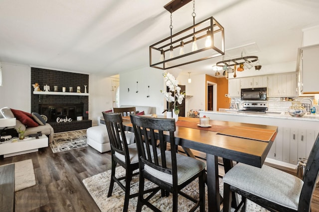 12817 Lascassas Pike, Milton, TN 37118 - dining space featuring dark wood finished floors and a fireplace