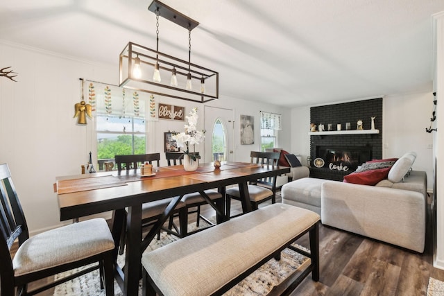 12817 Lascassas Pike, Milton, TN 37118 - dining space featuring crown molding, dark wood-type flooring, a brick fireplace, and a wealth of natural light