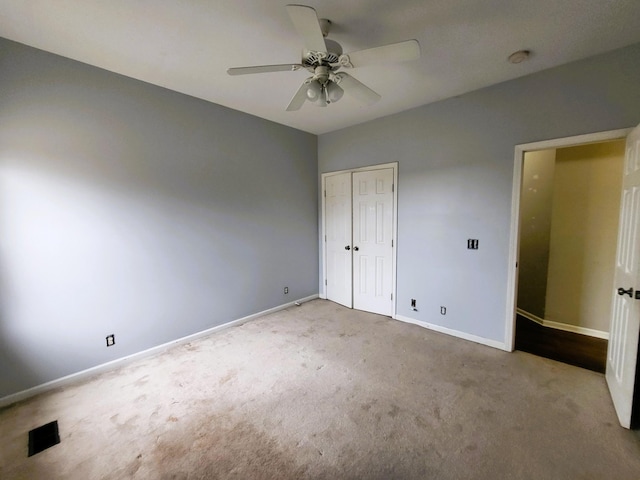 unfurnished bedroom with visible vents, carpet, baseboards, and a closet