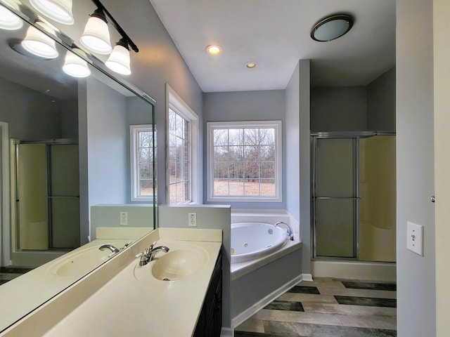 bathroom with a tub with jets, vanity, wood finished floors, and a shower stall