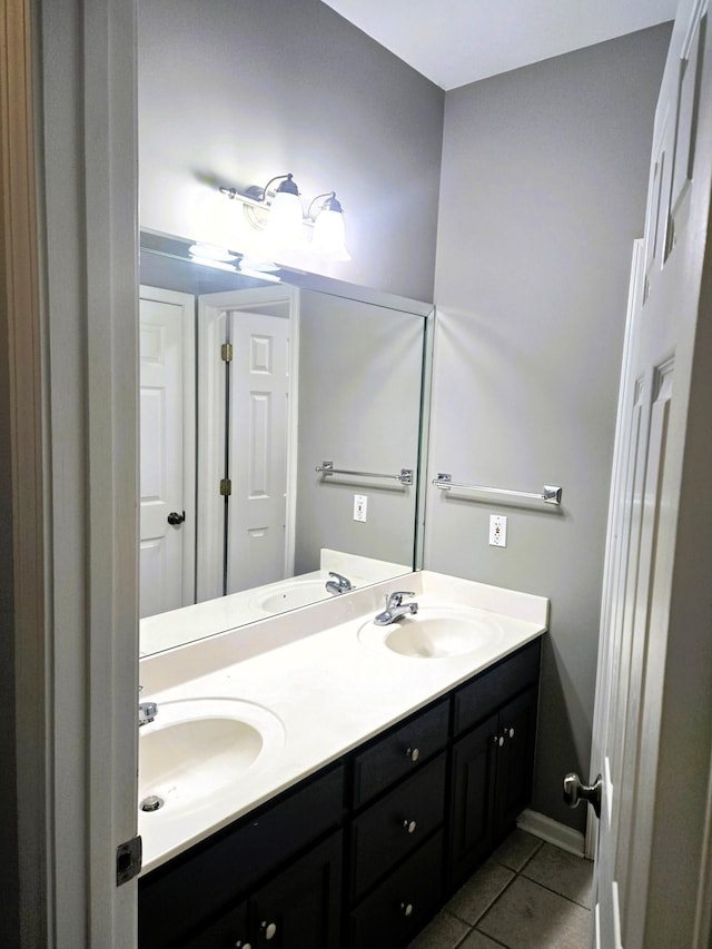 full bath with tile patterned flooring, a sink, and double vanity