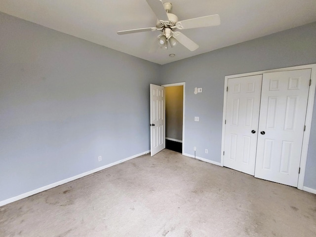 unfurnished bedroom featuring baseboards, carpet, ceiling fan, and a closet
