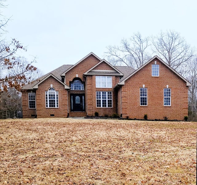 view of front of property with brick siding and roof with shingles