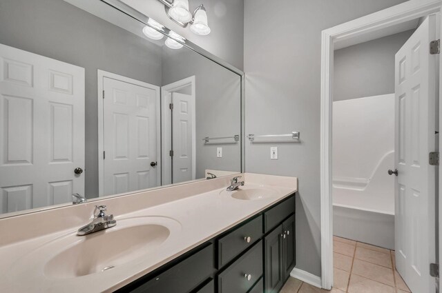 1031 Laurel Hill Dr, Dickson, TN 37055 - full bathroom featuring tile patterned flooring, double vanity, and baseboards
