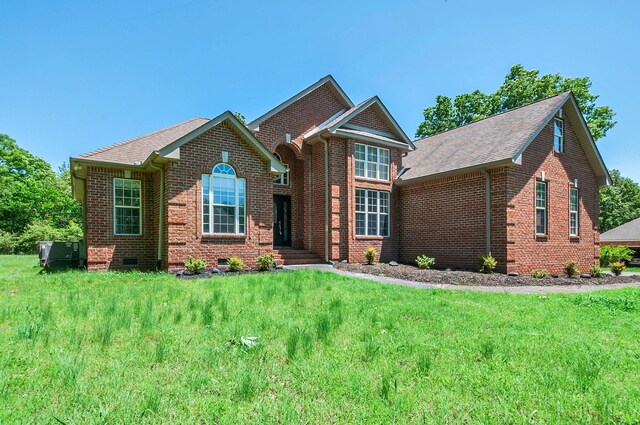 1031 Laurel Hill Dr, Dickson, TN 37055 - view of front facade with brick siding, a front yard, and a shingled roof