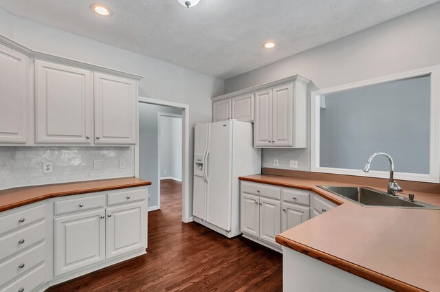 1031 Laurel Hill Dr, Dickson, TN 37055 - kitchen featuring a sink, white fridge with ice dispenser, white cabinetry, dark wood-style floors, and recessed lighting