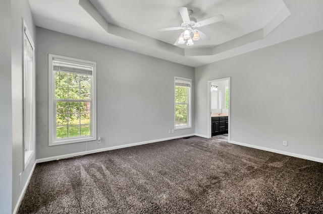 1031 Laurel Hill Dr, Dickson, TN 37055 - empty room featuring baseboards, a tray ceiling, dark carpet, and ceiling fan