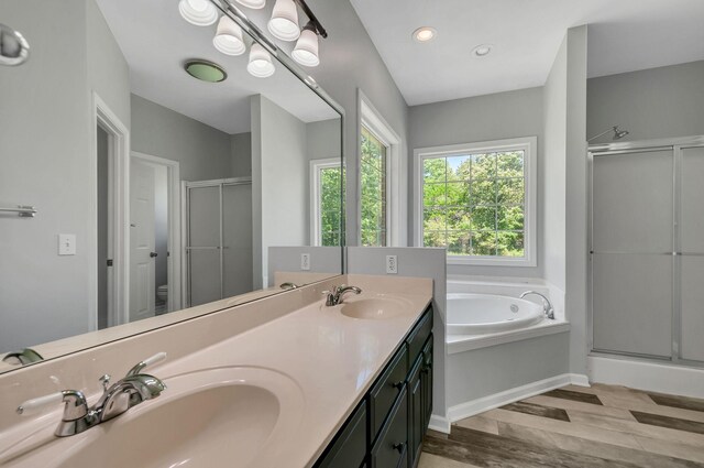 1031 Laurel Hill Dr, Dickson, TN 37055 - bathroom with wood finished floors, a stall shower, a garden tub, double vanity, and toilet