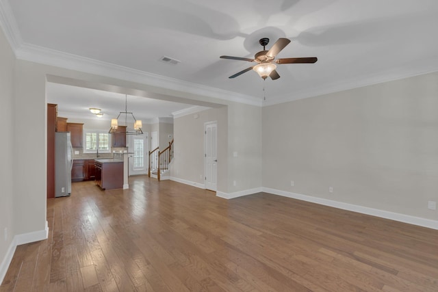 1020 Rural Plains Cir, Franklin, TN 37064 - unfurnished living room with hardwood / wood-style floors, a ceiling fan, baseboards, visible vents, and ornamental molding