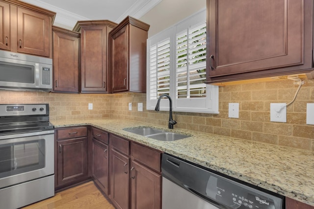 1020 Rural Plains Cir, Franklin, TN 37064 - kitchen with light stone counters, a sink, appliances with stainless steel finishes, and backsplash
