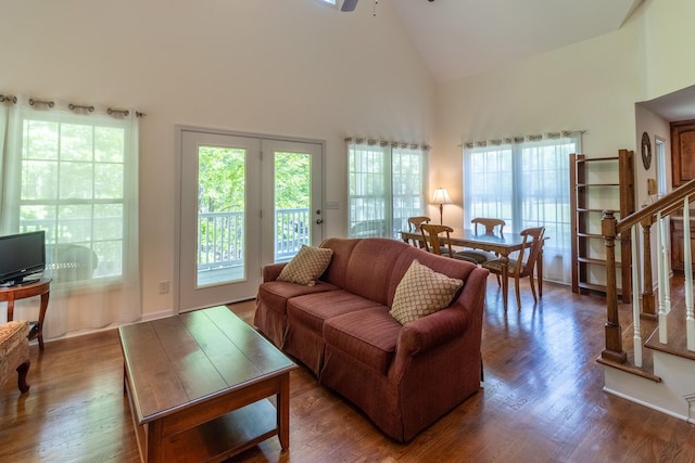 living area featuring high vaulted ceiling, ceiling fan, a healthy amount of sunlight, and wood finished floors