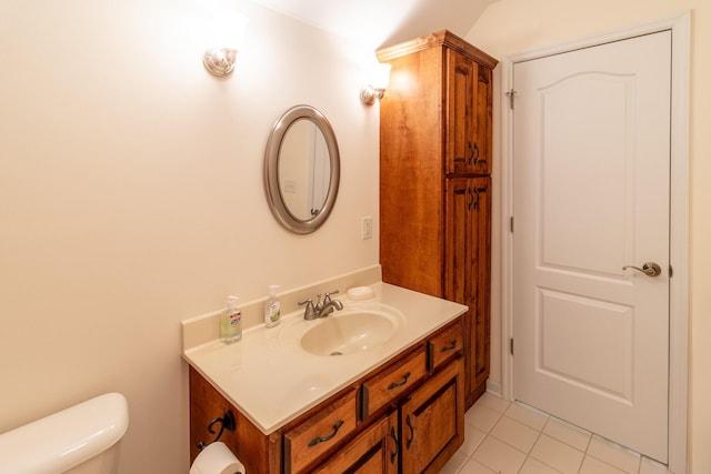bathroom with vanity, tile patterned flooring, and toilet