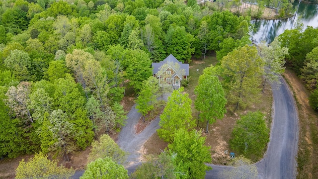 aerial view with a water view and a wooded view