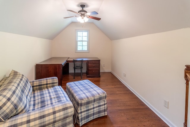 interior space featuring a ceiling fan, baseboards, vaulted ceiling, and dark wood-style floors