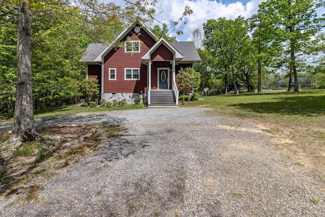 view of front of home featuring a front yard, driveway, and crawl space