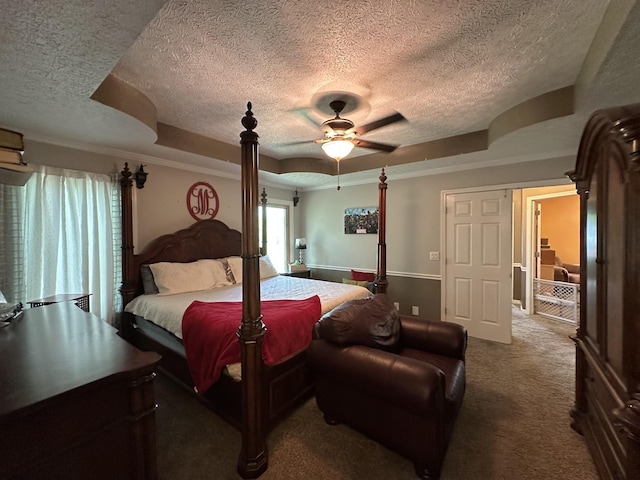 bedroom with crown molding, ceiling fan, carpet flooring, and a textured ceiling