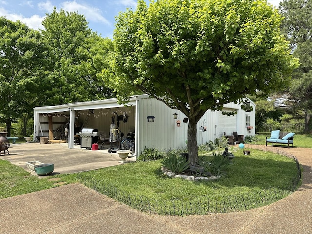 view of pole building featuring a lawn and fence