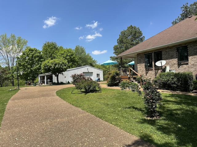 exterior space with a detached garage, an outdoor structure, and driveway