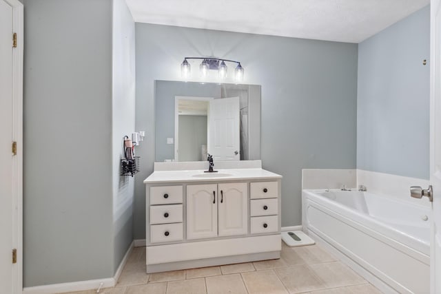 bathroom with baseboards, tile patterned flooring, a bath, and vanity