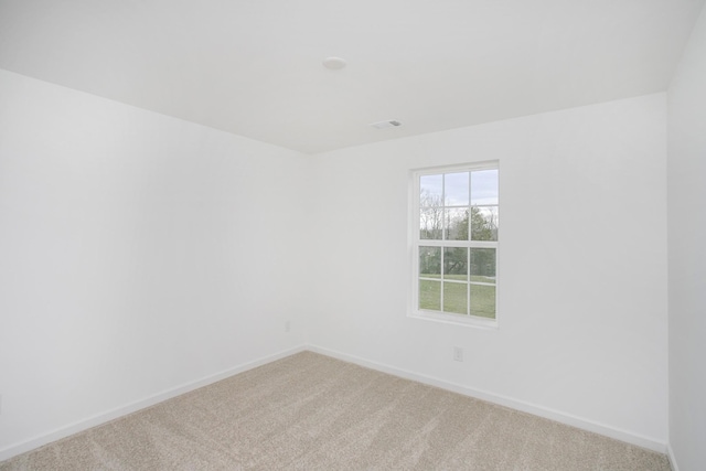 empty room with baseboards and carpet flooring