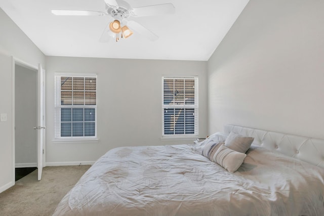 carpeted bedroom with baseboards, vaulted ceiling, and ceiling fan