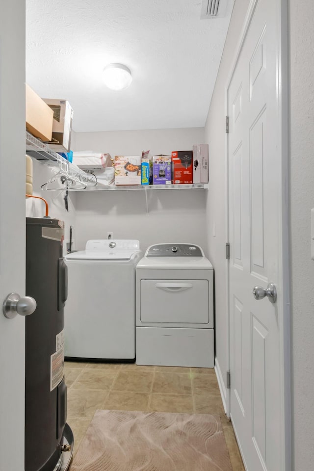 laundry area with water heater, laundry area, and washer and dryer