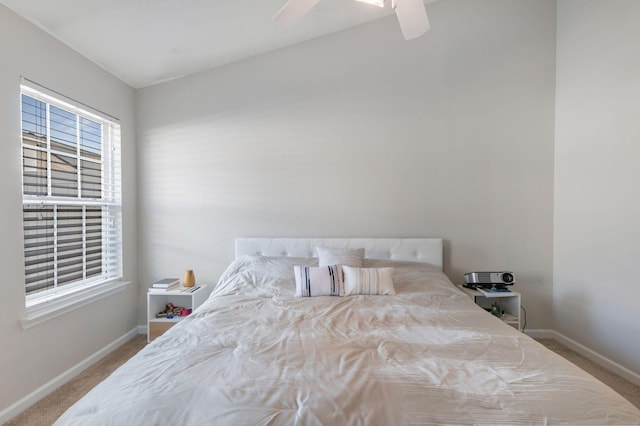 bedroom featuring baseboards, a ceiling fan, and carpet flooring
