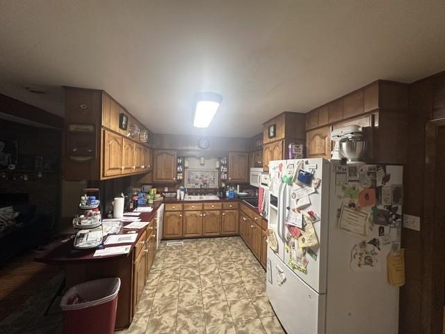 kitchen with white appliances and brown cabinets