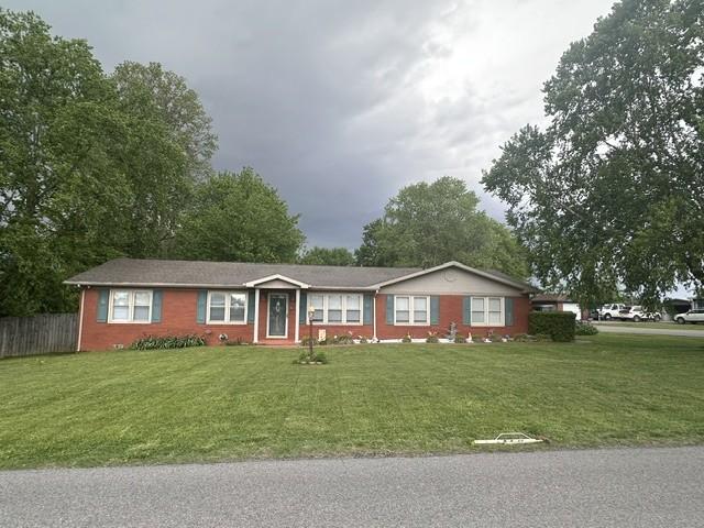 ranch-style house with fence and a front yard