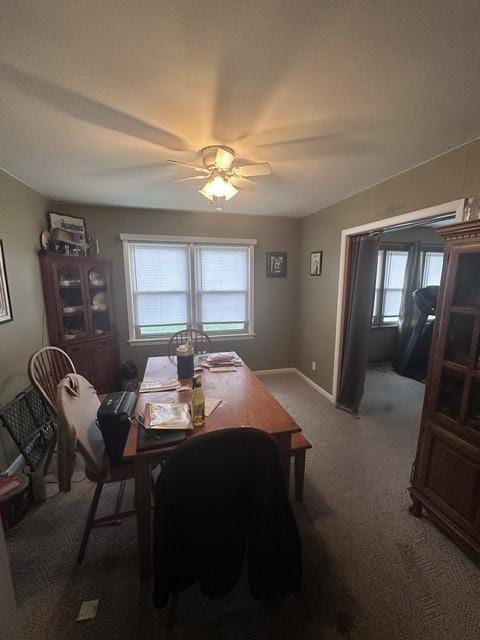 dining room featuring baseboards, carpet flooring, and a ceiling fan