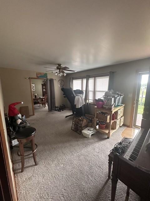 carpeted living room featuring a ceiling fan