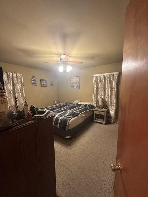 carpeted bedroom featuring a ceiling fan