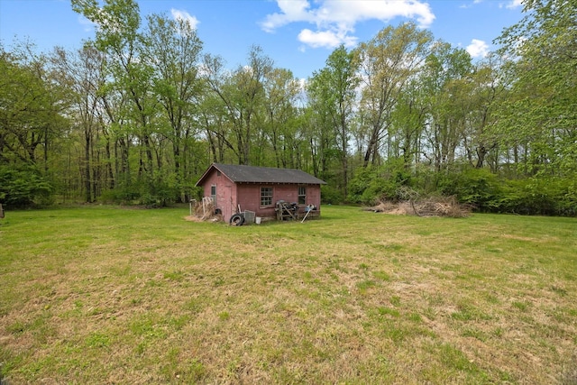 view of yard featuring an outbuilding and a forest view