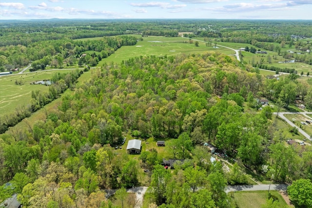 bird's eye view with a wooded view