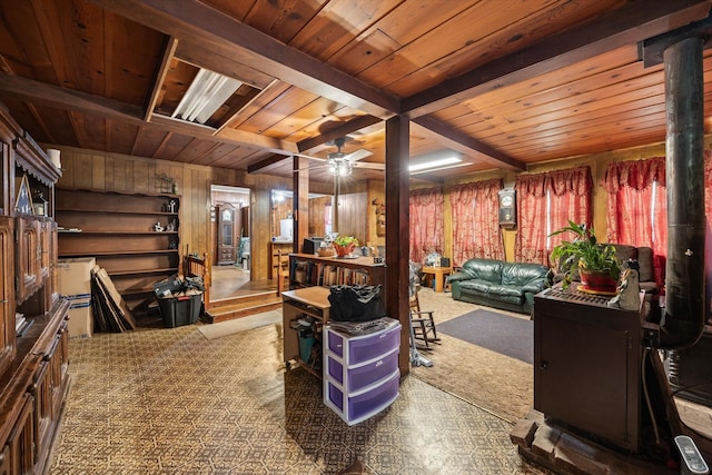 interior space with carpet floors, wood walls, wood ceiling, and ceiling fan