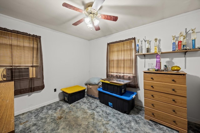 interior space featuring baseboards, ornamental molding, and a ceiling fan