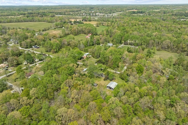 birds eye view of property with a view of trees