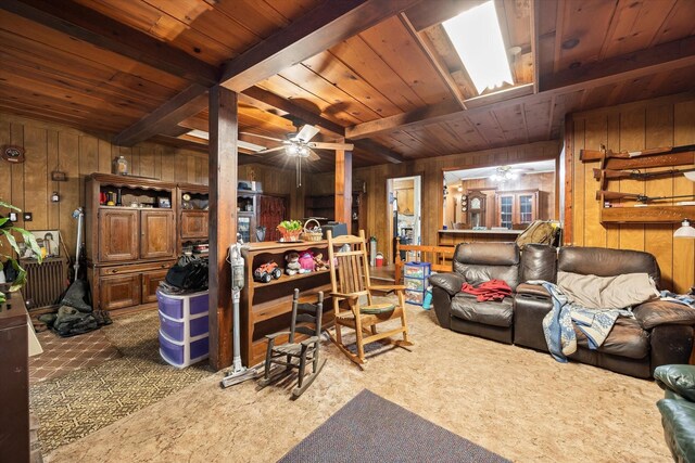 carpeted living room featuring wood ceiling, beam ceiling, and wooden walls
