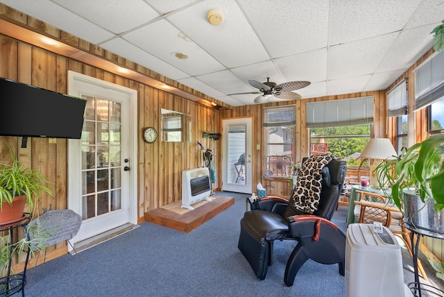757 Acorn Dr, Clarksville, TN 37043 - sitting room featuring wood walls, heating unit, a healthy amount of sunlight, and carpet flooring