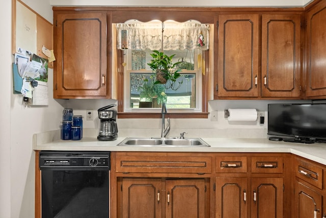 757 Acorn Dr, Clarksville, TN 37043 - kitchen with brown cabinetry, a sink, dishwasher, and light countertops