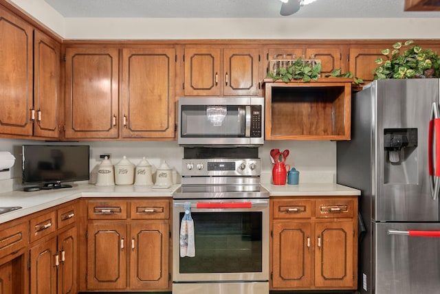 757 Acorn Dr, Clarksville, TN 37043 - kitchen featuring light countertops, brown cabinetry, and stainless steel appliances