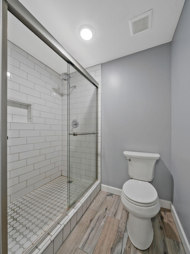 3120 Trenton Rd, Clarksville, TN 37040 - full bathroom with visible vents, wood finished floors, toilet, baseboards, and a stall shower