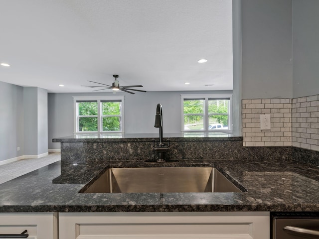 3120 Trenton Rd, Clarksville, TN 37040 - kitchen with dark stone counters, backsplash, white cabinetry, and a sink