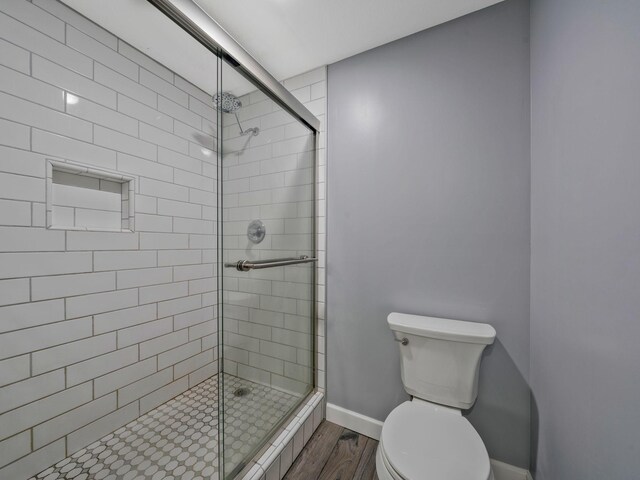 3120 Trenton Rd, Clarksville, TN 37040 - bathroom featuring baseboards, a stall shower, toilet, and wood finished floors