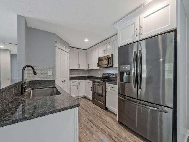 3120 Trenton Rd, Clarksville, TN 37040 - kitchen featuring tasteful backsplash, a sink, dark stone counters, stainless steel appliances, and white cabinetry