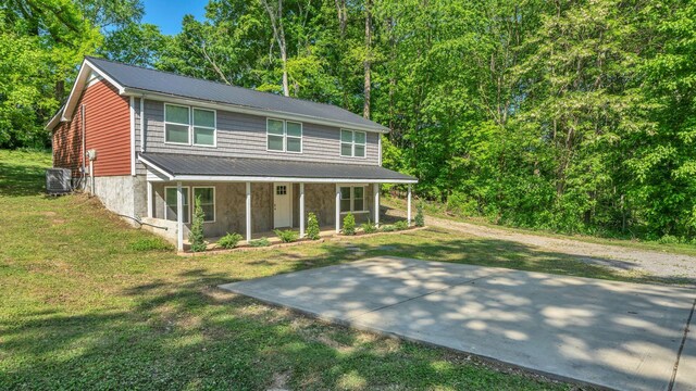 3120 Trenton Rd, Clarksville, TN 37040 - view of front of house featuring central AC unit, covered porch, a front yard, and metal roof